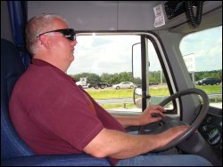 Professional truck driver Mike Simons wearing his polarized sunglasses so he can see more easily while driving.