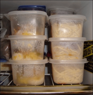 Stacks of pre-portioned meals in plastic food storage bowls with lids.