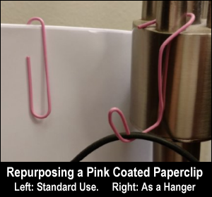 Repurposing a pink coated paperclip. Left: standard use. Right: as a hanger.