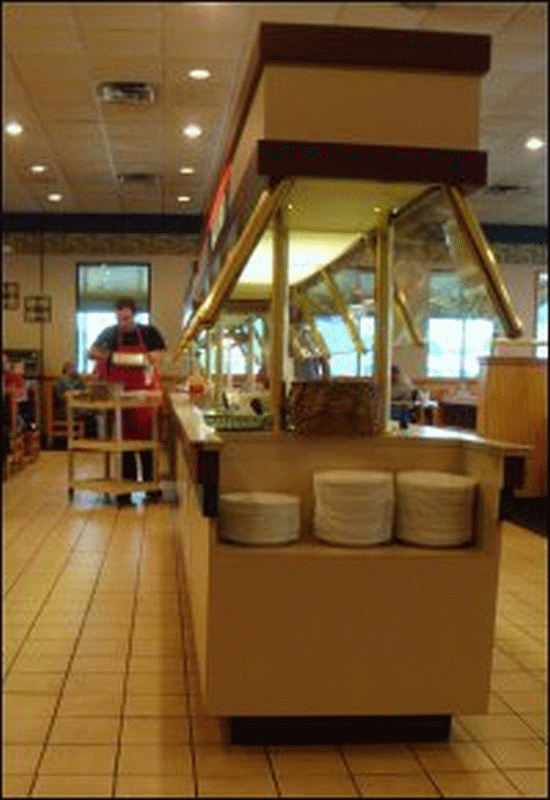 Staff at North 40 Truck Stop refilling the hot bar on the buffet.