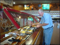Professional driver Mike Simons visits the entree hot bar at the Petro restaurant in Glendale, KY.