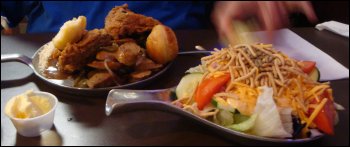 The plate on the left was what Mike got on his first trip to the hot bar at the Petro Iron Skillet Restaurant in Kenly, NC. The plate on the right had his salad. Notice the real butter in the cup. This had been in a special crock to keep it cold.