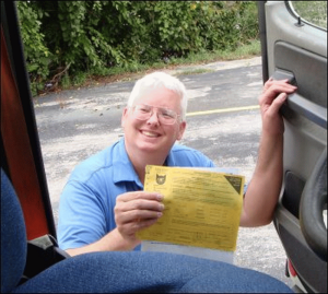 Mike smiles because his CAT Scale ticket says that the weights on all axles of his truck are legal and well balanced.