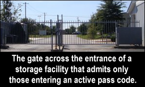 The gate across the entrance of a storage facility that admits only those entering an active pass code.