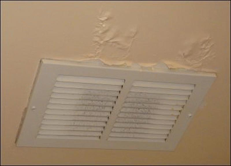 The cracked paint near a vent with a little dust on it in my shower room at the Flying J in Fort Chiswell, VA.