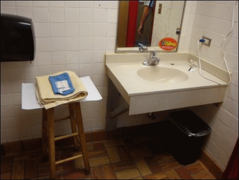 A photo of the sink, counter and movable seat in Shower #1 at the Pilot in Pleasant Hill, NC.