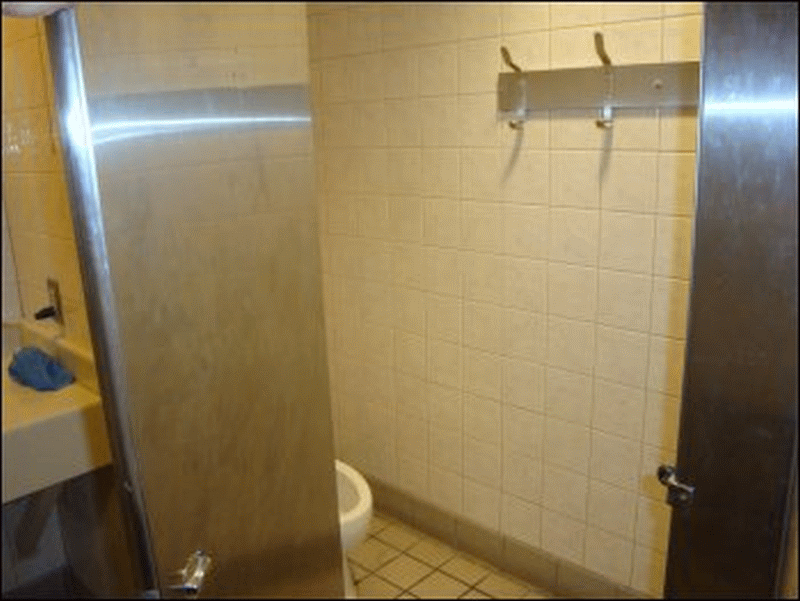 A view of the 'toilet room' in Shower #11 at the Pilot in Breezewood, PA. You can see the closeable door, toilet and rack with four more towel hooks, but cannot see the sink back to the right.