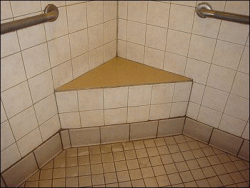 The triangular seat in the shower stall of Shower #11 at the Pilot in Breezewood, PA.