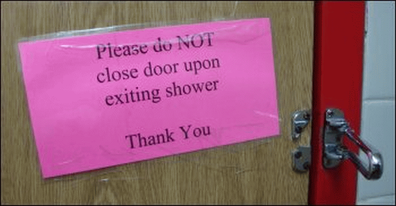 Broken door restrictor and sign on back of door of Shower #8 at Pilot at Staunton, VA.