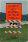 A sign reading: 'Maintain safe distance between vehicles'