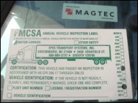 Magtec sticker on driver side window above FMCSA inspection sticker.