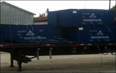 Photo showing shifted freight, broken bundle straps and broken load straps after trucker braked truck hard to avoid cut off collision with car.