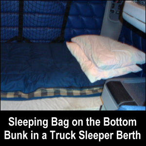 Sleeping bag on bottom bunk in a truck sleeper berth.