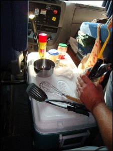 A small kitchen countertop has been made on the top of an ice chest.