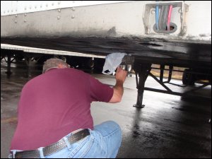 Professional driver Mike Simons gives The Enforcer king pin lock as security tug to ensure proper installation on his dropped trailer.