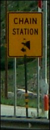 Close-up of tire chain up station sign along I-70 in Colorado.