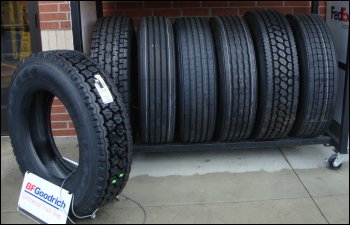 Tire display showing steer, drive and tractor tires with different configurations.