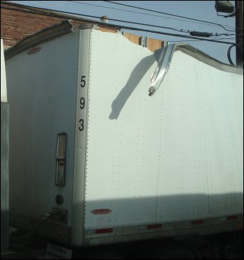 Roof damage on the front of a trailer.