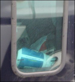 Trash visible through the foot-level passenger side window.