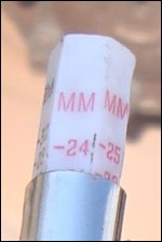 Close-up of tread depth gauge showing millimeters.