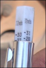 Close-up of tread depth gauge showing inches as expressed in 32nds.