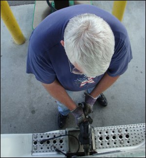 Overhead shot of Mike Simons putting fuel into a Freightliner.