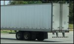 The trailer tandem axles under the rear of a commercial motor vehicle.