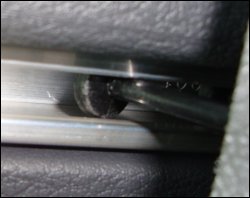 A close-up view of the connector between the truck curtain and the track in which it is installed. Sometimes they don't slide as they should and get 'sticky'. Here's how to get them to slide again.