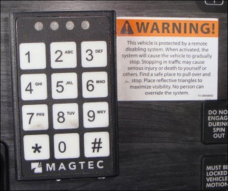 Magtec keypad and warning label on dash of a large truck.