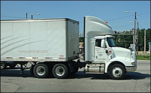 A daycab tractor pulling a long trailer.