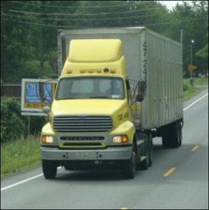 A daycab tractor pulling a long trailer.