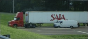 This daycab tractor pulls a long trailer.