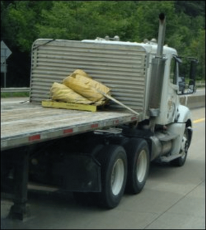 A local driver pulls a flatbed trailer.