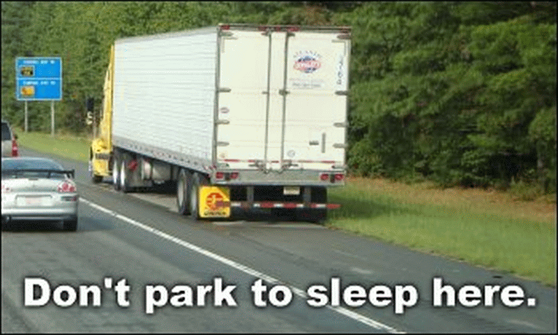 Truck parked on the shoulder of an interstate highway with no emergency triangles out.