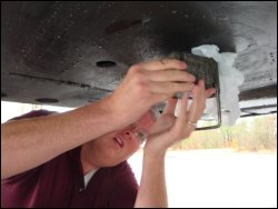 Installing the Enforcer king pin lock over a plastic grocery bag over the king pin to keep the lock free of grease.