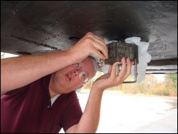 Mike inserts the key into the kingpin lock to lock it in place.