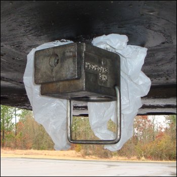 The Enforcer kingpin lock is in place over a plastic grocery bag on a trailer kingpin