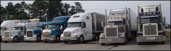 Trucks parked in a truck stop. The lack of adequate truck parking is part of what gave rise to Jason's Law.