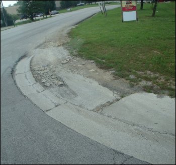 Curb damage from making a shortcut with truck tracking.