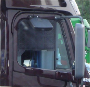 Truck window screen installed in a large truck: brown tractor.