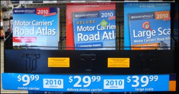 A display of truckers atlas books on sale at a truck stop.