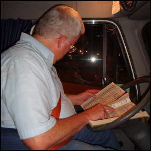 Mike Simons looks at two publications -- The Trucker's Friend and The Next Exit -- before pulling out of a parking spot.