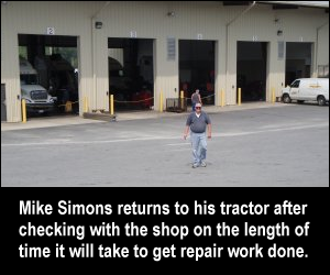 Mike Simons returns to his tractor after checking with the shop on the length of time it will take to get repair work done.