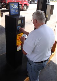 Professional driver Mike Simons enters the information into the card reader so that he can get fuel for the truck he drives. At this participating location, he receives one point for each gallon of fuel he gets as a driver reward.