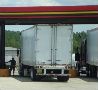 A professional driver prepares to put fuel in his commercial motor vehicle at a truckstop.