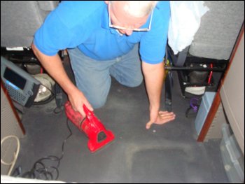 Mike Simons cleaning his truck with a Dirt Devil hand held vacuum cleaner.