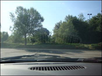 Photo taken through windshield of car, showing glare reflection of air vent.