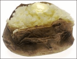 A baked potato, split with butter on top.