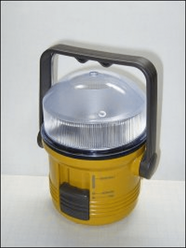 Flashlight shaped like a lantern with handle and flat bottom.