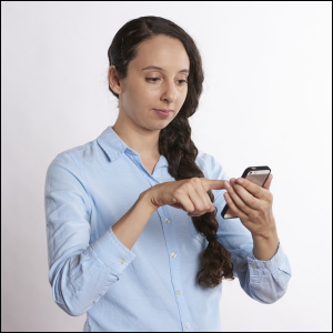 Woman looking on cell phone, checking something.